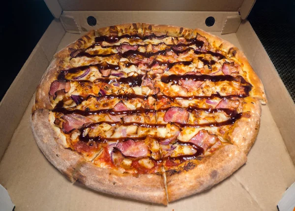 Inside of a Pizza box. Classic pizza in a cardboard box. Wide angle view from above. Pizza delivery, menu. Fast food, crusty dough