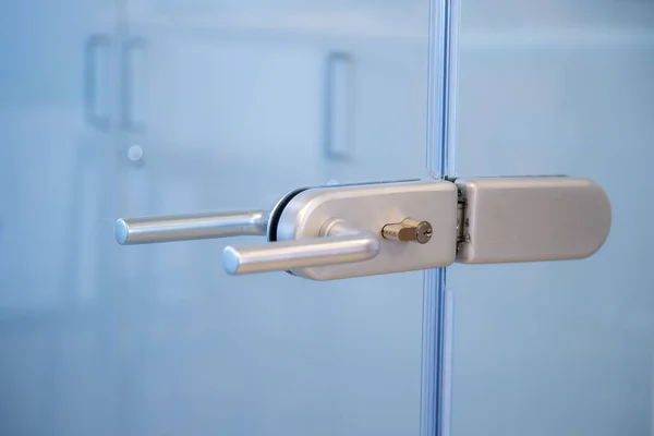 Modern, contemporary glass door lock handle in modern business office. — Stock Photo, Image