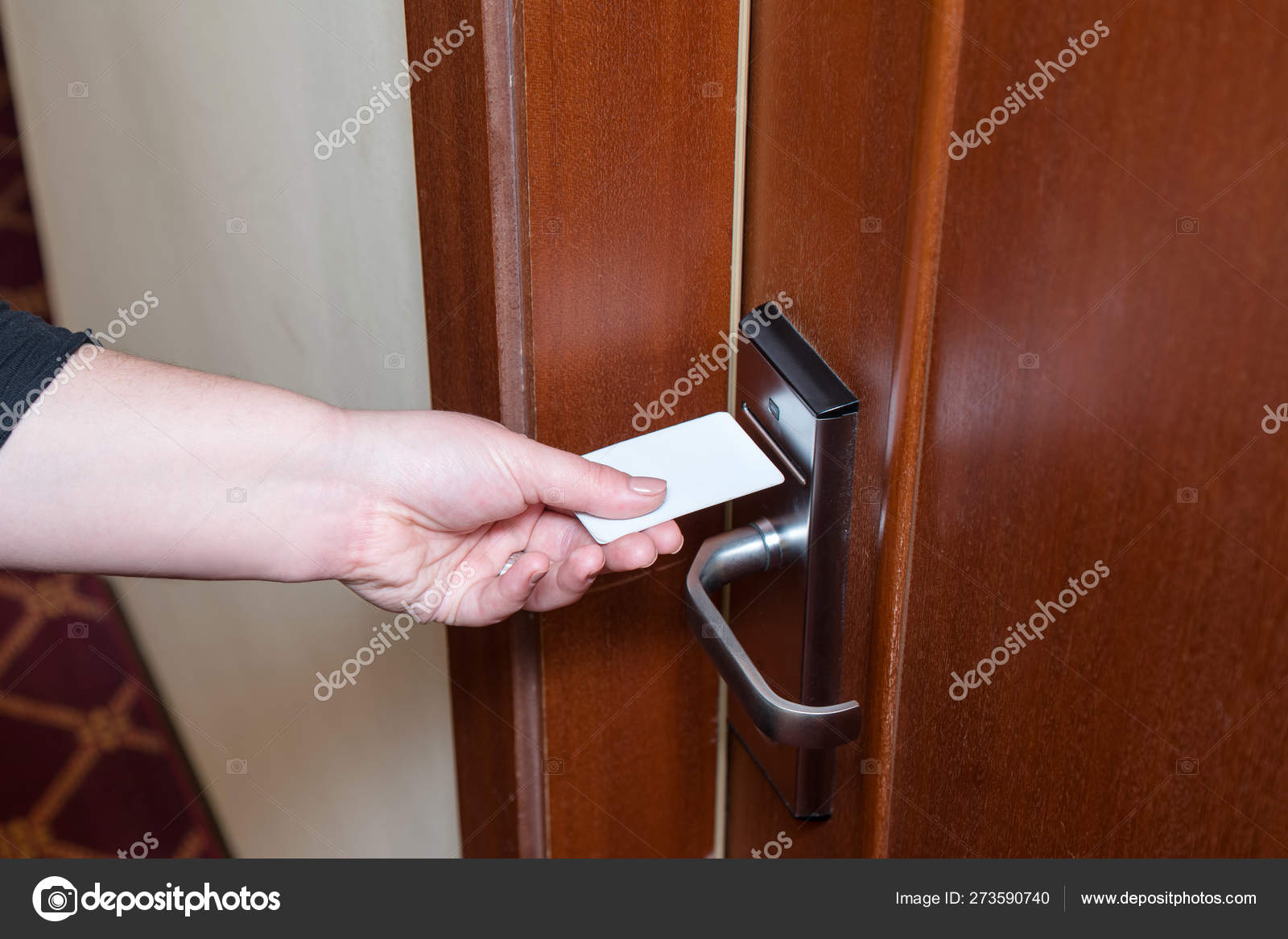 Female Hand Putting Key Card Switch In To Open Hotel Room Door