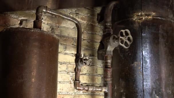 Rusty boiler room pipes. Old metal boiler generating heating and delivering it to home through pipeline. Hot water or gas is being delivered with this system — Stock Footage Rusty Boiler Room Pipes Old Metal Boiler Generating Heating Delivering Stock Video