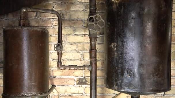Rusty boiler room pipes. Old metal boiler generating heating and delivering it to home through pipeline. Hot water or gas is being delivered with this system — Stock Footage Rusty Boiler Room Pipes Old Metal Boiler Generating Heating Delivering Stock Video