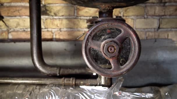 Rusty boiler room pipes. Old metal boiler generating heating and delivering it to home through pipeline. Hot water or gas is being delivered with this system — Stock Footage Rusty Boiler Room Pipes Old Metal Boiler Generating Heating Delivering Royalty Free Stock Video