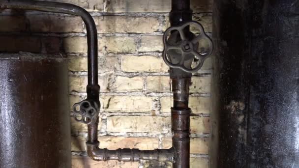 Rusty boiler room pipes. Old metal boiler generating heating and delivering it to home through pipeline. Hot water or gas is being delivered with this system — Stock Footage Rusty Boiler Room Pipes Old Metal Boiler Generating Heating Delivering Video Clip