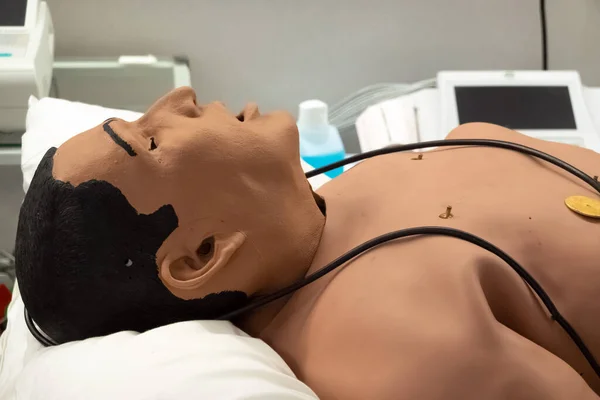 Defibrillator on a dummy doll for practice. Cpr dummy for training purposes in hospital. First aid training class for medical students