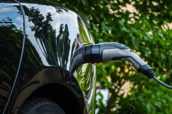 绿色环境背景下电动汽车充电器插头 新能源汽车 Nev正在装载电力 生态学 现代汽车 — 图库照片