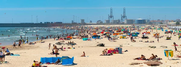Porto, Portekiz - Haziran 2019: Güneşli bir günde Matosinhos sahilinde güneşlenen insanlar. Portekiz 'in kumlu sahillerinde yazın tadını çıkaran aileler.