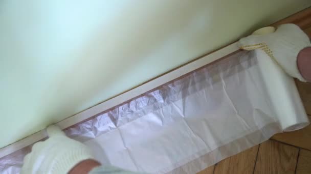 Close Worker Hands Gloves Sticking Cellophane Protect Hard Wood Floors — Stock Video