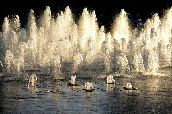日没時に太陽の光に照らされた市内中心部の噴水 — ストック写真