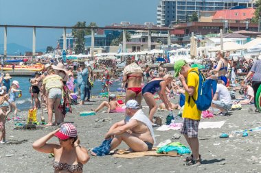 SOCHI, RUSSIA - 9 JUNE 2019: Rocky city beach, crowded with tourists. The beginning of the season. clipart