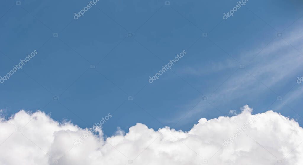 White fluffy clouds on a blue background with a place to write over them.