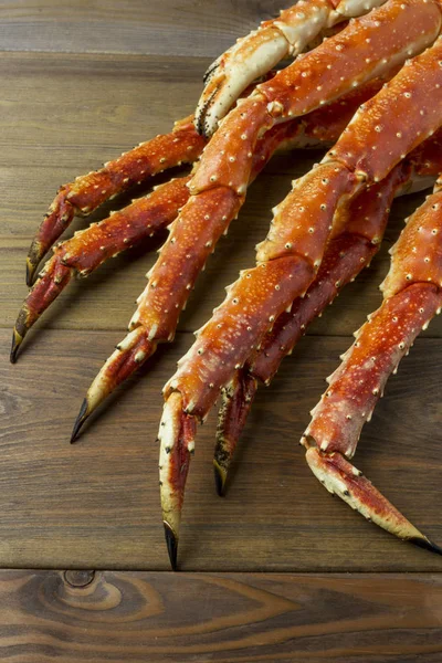 Tasty fresh luxury king kamchatka crab\'s claw on wooden background