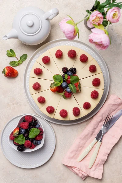 Birthday cheesecake with berries on light background