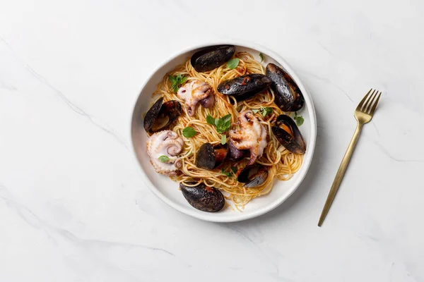 Italian pasta with mussels and octopus in white plate — Stock Photo, Image