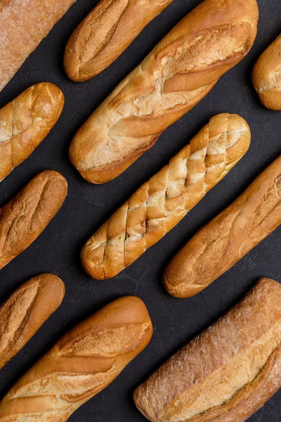 Variety kind of bread is rows at black background