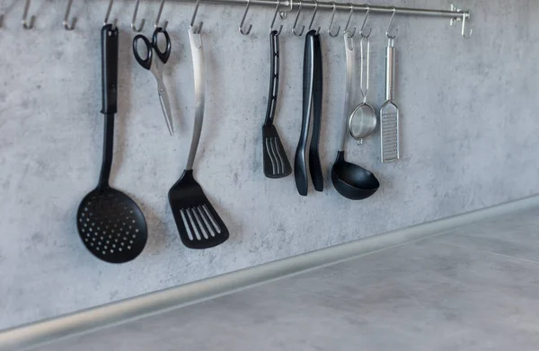 Modern collection of kitchen equipment at gray background.