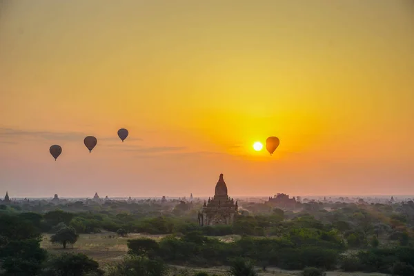 A beautiful sunrise with balloons floating in the air in Bagan is a city of thousands of Buddhist pagodas. Myanmar