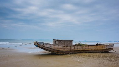 Deniz kıyısındaki eski balıkçı teknesi. Mong Cai, Vietnam.
