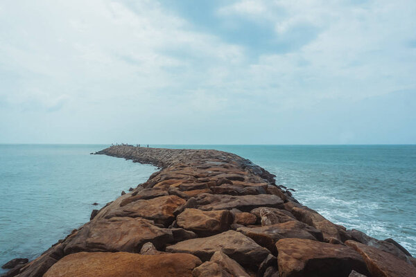 Stone pier in the Bay of Bengal. City Kanyakumari, India