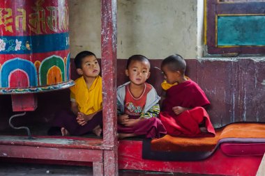 Pelling, Sikkim, India - May 11, 2017: Buddhist children monks conduct prayer services in the temple clipart