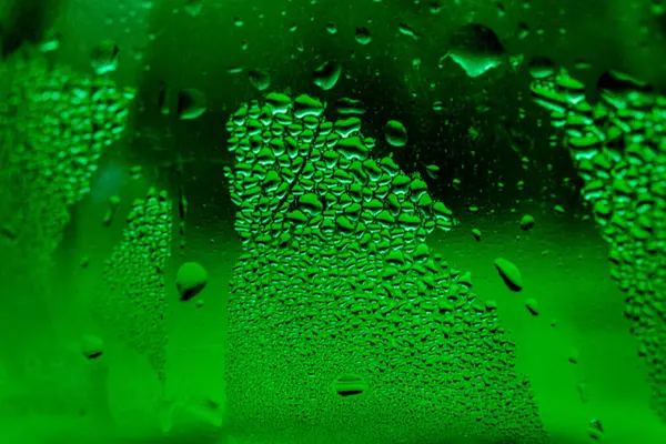 Green misted glass, drops, abstract background