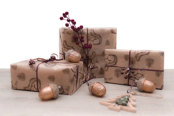 Christmas gifts boxes in brown craft paper with christmas glass toys