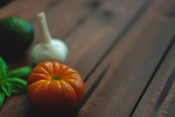 Assorted vegetables on a dark brown background great for farm-to-table messaging.