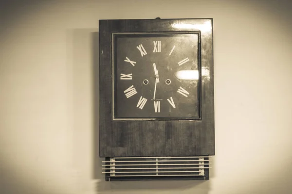 Old wooden mechanical retro clock-clock on the wall in the Russian house