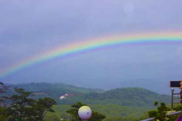 Bright colorful rainbow after rain in the mountains in the tropics