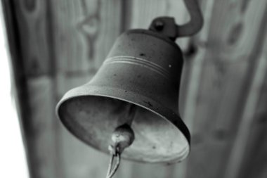 Eski köylü pirinç çanı Rus kulübesinin girişinde.