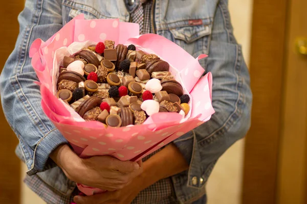 Beautiful original sweet bouquet of sweets, chocolate and cookies for the holiday