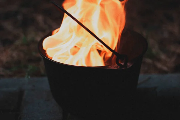 Orange blazing raging fire in a cast iron pot