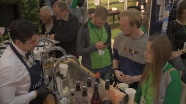 Adam şurubu bardağa doldurup musluk suyuyla sulandırıyor.