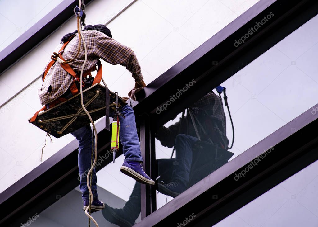 Cleaning the outside of the high building.