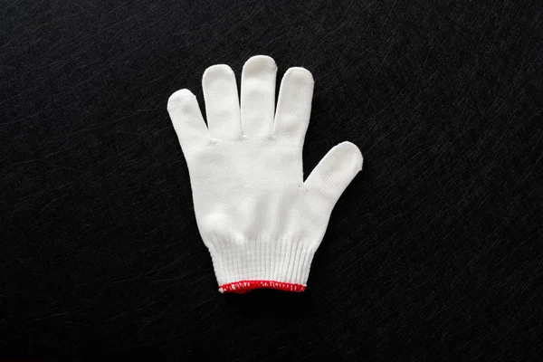 white glove with gesture of FIVE on black background