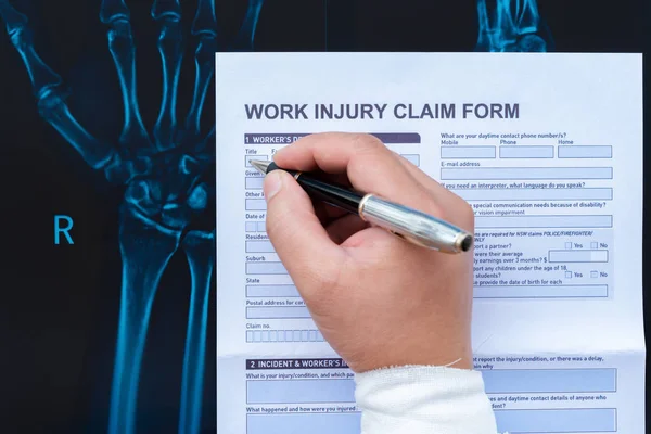 Filling Work Injury Claim Form Wrapped Hand Top Ray Film — Stock Photo, Image