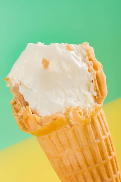 Ice Cream Cone Yellow Green Background Some Bites Close Vertical — Stock Photo, Image