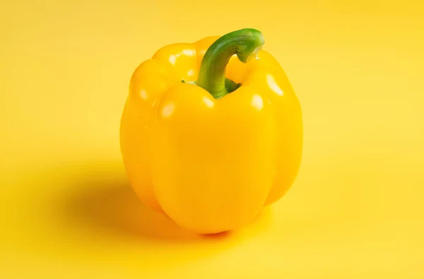 fresh yellow bell pepper on a yellow background