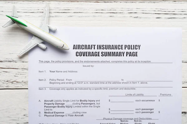 top view aircraft insurance policy coverage form and an airplane model concept of travel insurance