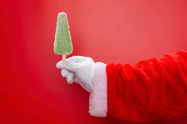 Santa Claus Sosteniendo Una Paleta Frijol Verde Frente Fondo Rojo — Foto de Stock