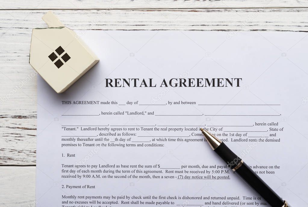 top view rental agreement contact with an architectural model and a pen