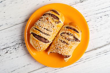 Üstten Görünüm kırmızı fasulye çöreği bir bazı beyaz ahşap arka plan üzerinde ısırır