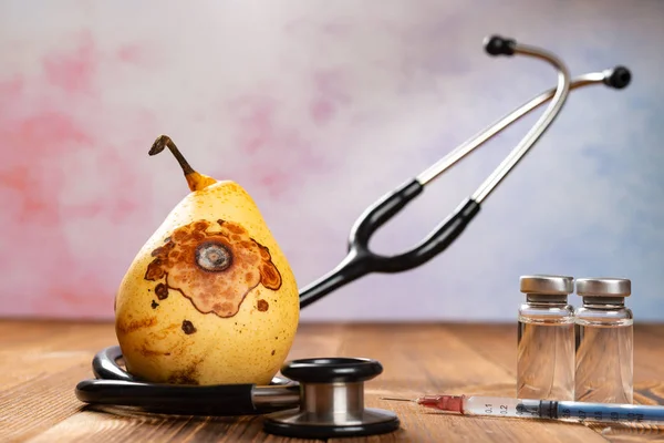 Rotten Pear Surrounded Stethoscope — Stock Photo, Image