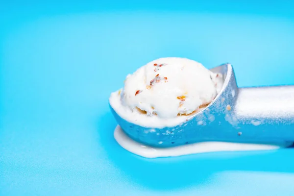 chestnut and red bean ice cream starts melting and spliting out on blue background