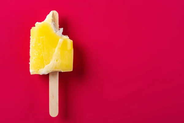 Yellow Popsicle Couple Bites Red Background — Stock Photo, Image
