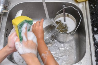 sabunlu sünger ile mutfak lavabosunda bulaşık yıkama çocuklar