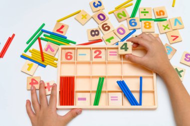 sayma çubukları kullanarak çıkarma denklemi yapan çocuk