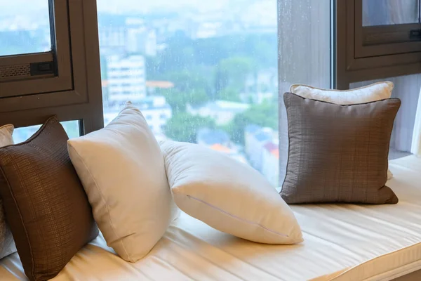 resting area of a cozy window seat with cushion in the morning horizontal composition
