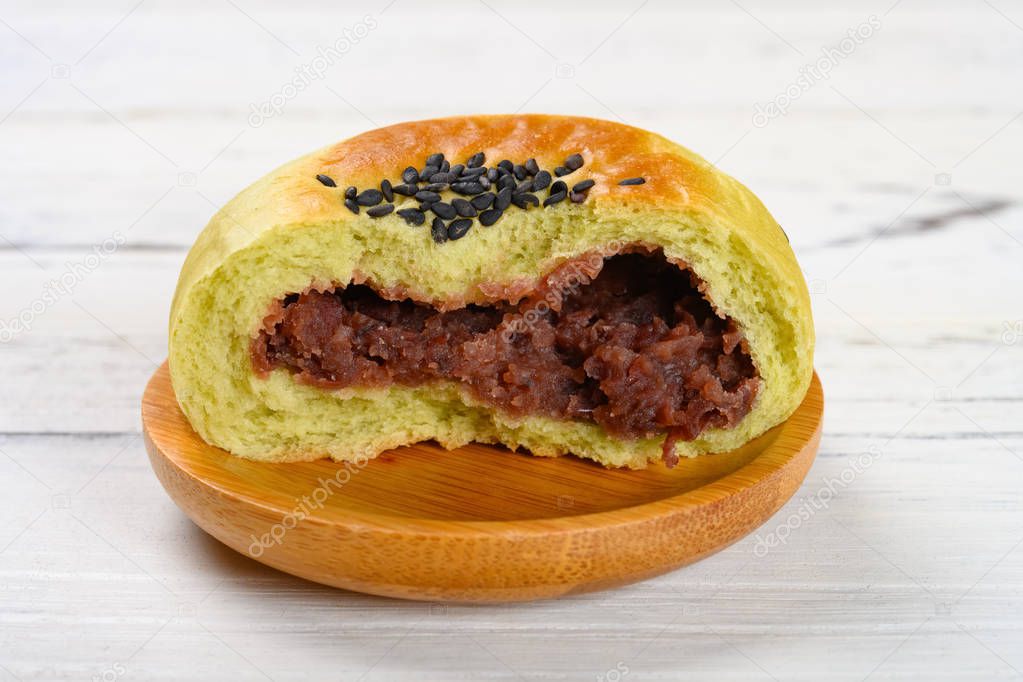 side view cut out red bean paste cake on a wood table
