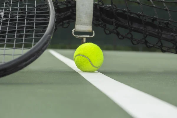 tennis ball and racket at tennis court, close up tennis ball in court