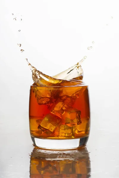 加冰的威士忌在玻璃与飞溅 — 图库照片